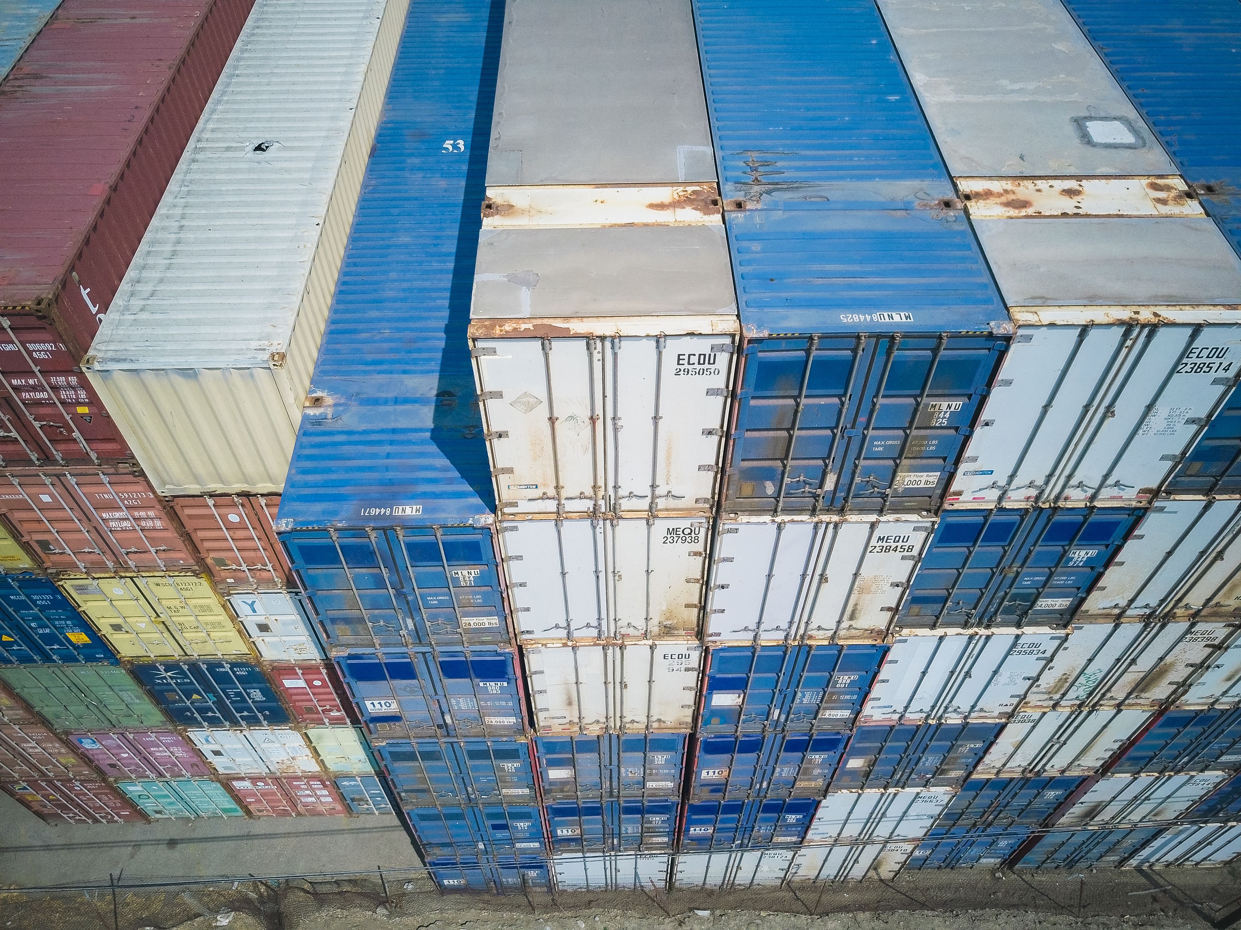 Shipping containers moving through a busy logistics terminal
